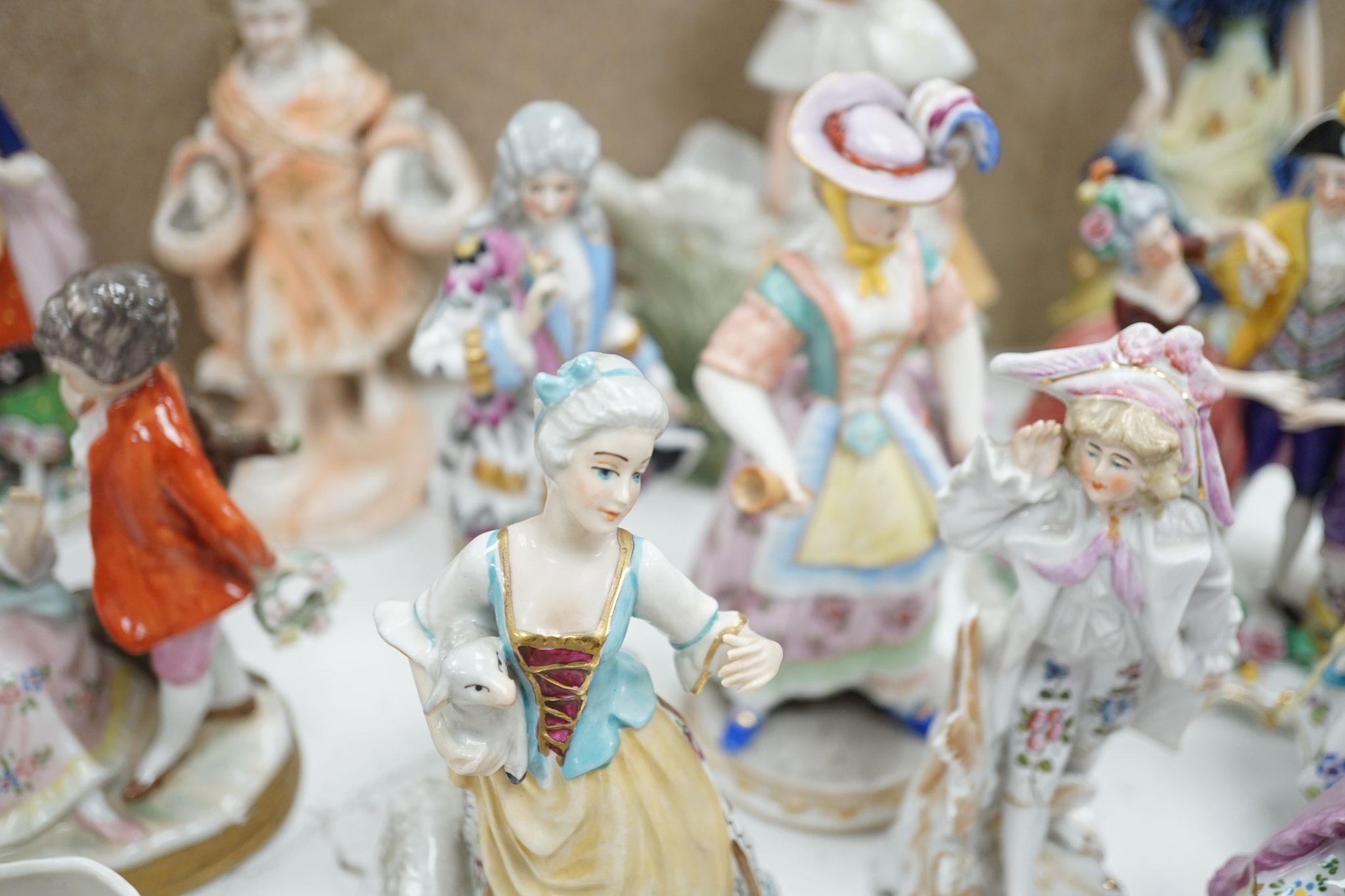 A large collection of small to medium German, French and English porcelain figurines and groups, tallest 18cm